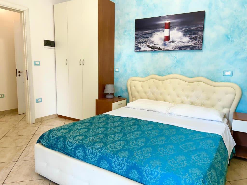 Camera doppia con letto matrimoniale e parete azzurra